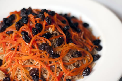 Kabuli - Pallow (Afghan-style rice) baked with chunks of lamb tenderloin, raisins and glazed julienne of carrots.